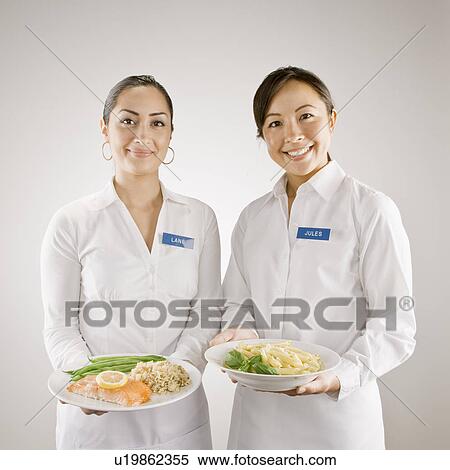 Servers in nametags with plates of food View Large Photo Image Stock Photography - Servers in nametags with plates of food. Fotosearch