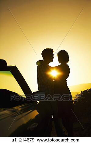 Stock Photo - Silhouette of couple hugging. Fotosearch