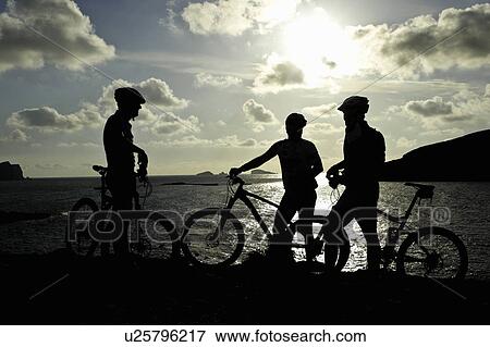 Silhouettes of mountain bikers by lake View Large Photo Image Stock Photo - Silhouettes of mountain bikers by lake. Fotosearch