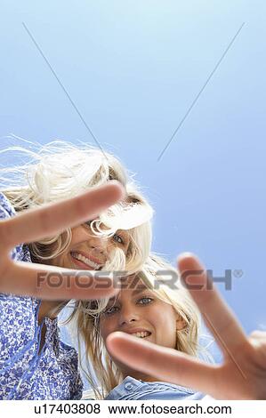 Sisters making peace sign together View Large Photo Image Stock Photo - Sisters making peace sign together. Fotosearch