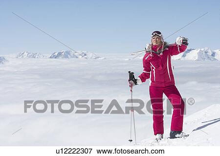 Skier standing on mountainside View Large Photo Image Stock Photo - Skier standing on mountainside. Fotosearch