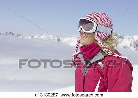 Stock Photo - Skier standing on mountainside. Fotosearch