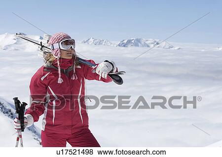 Stock Photo - Skier standing on mountainside. Fotosearch