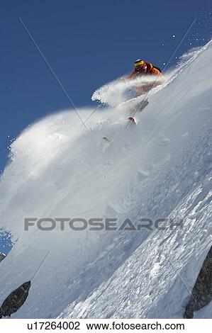 Skier turning on steep mountain face View Large Photo Image Stock Image - Skier turning on steep mountain face. Fotosearch