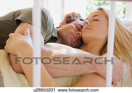 Sleeping couple hugging in bed View Large Photo Image Stock Image - Sleeping couple hugging in bed. Fotosearch