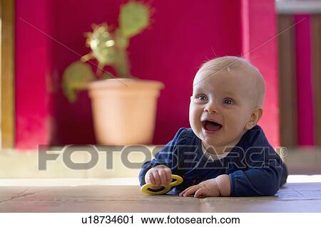 Smiling baby crawling on floor View Large Photo Image Stock Image - Smiling baby crawling on floor. Fotosearch