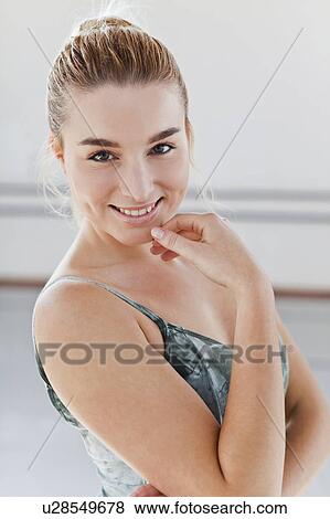 Smiling ballet dancer touching her chin View Large Photo Image Stock Photo - Smiling ballet dancer touching her chin. Fotosearch