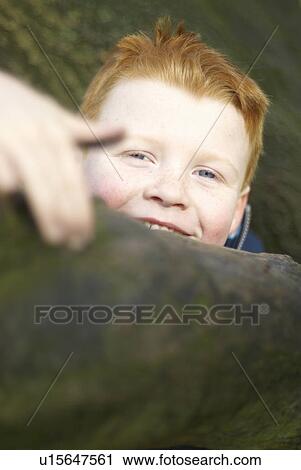Smiling boy climbing tree View Large Photo Image Stock Image - Smiling boy climbing tree. Fotosearch