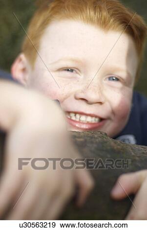 Smiling boy climbing tree View Large Photo Image Stock Photo - Smiling boy climbing tree. Fotosearch