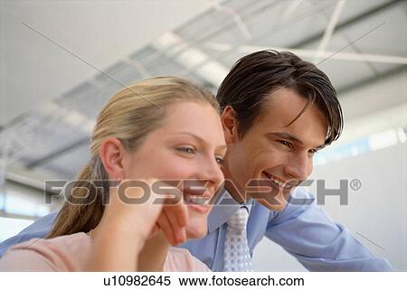 Stock Photography - Smiling business people working together. Fotosearch