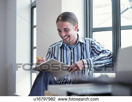 Smiling businessman writing in office View Large Photo Image Stock Image - Smiling businessman writing in office. Fotosearch