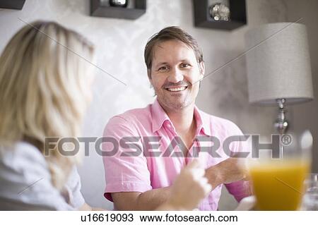 Smiling couple at breakfast table View Large Photo Image Stock Image - Smiling couple at breakfast table. Fotosearch