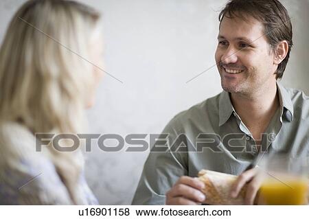 Smiling couple at breakfast table View Large Photo Image Stock Photo - Smiling couple at breakfast table. Fotosearch