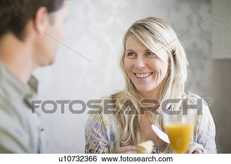 Smiling couple at breakfast table View Large Photo Image Stock Photograph - Smiling couple at breakfast table. Fotosearch