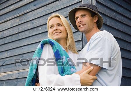 Picture - Smiling couple hugging outdoors. Fotosearch