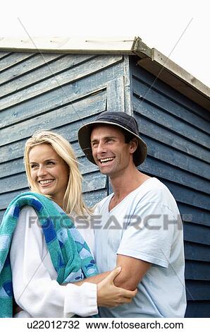 Smiling couple hugging outdoors View Large Photo Image Stock Image - Smiling couple hugging outdoors. Fotosearch