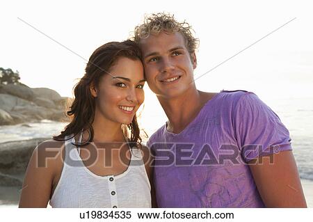 Smiling couple hugging outdoors View Large Photo Image Stock Photography - Smiling couple hugging outdoors. Fotosearch