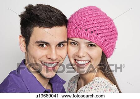 Stock Image - Smiling couple standing together. Fotosearch
