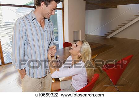 Smiling couple talking at home View Large Photo Image Stock Image - Smiling couple talking at home. Fotosearch