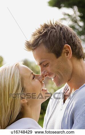 Smiling couple touching noses outdoors View Large Photo Image Stock Photo - Smiling couple touching noses outdoors. Fotosearch