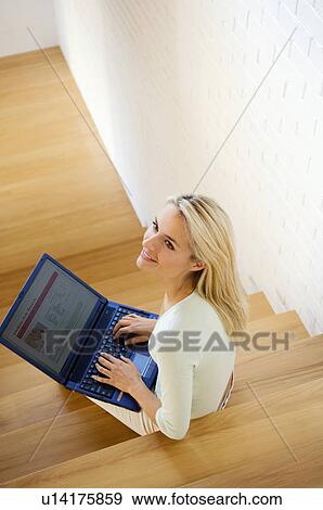Stock Photo - Smiling couple using laptop together. Fotosearch