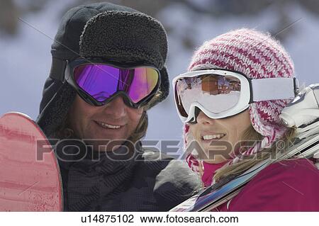 Smiling couple wearing ski goggles View Large Photo Image Stock Image - Smiling couple wearing ski goggles. Fotosearch