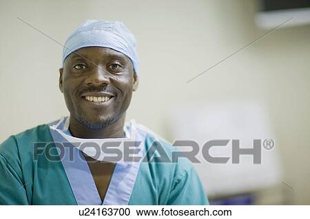 Smiling doctor with loosened mask View Large Photo Image Stock Image - Smiling doctor with loosened mask. Fotosearch