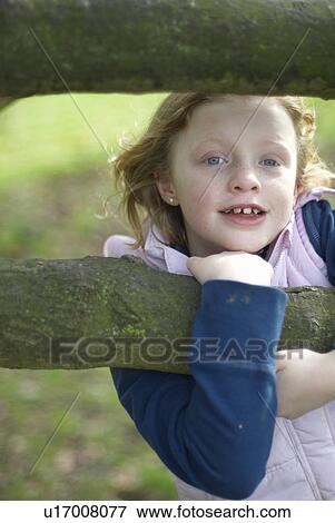 Smiling girl climbing tree View Large Photo Image Stock Photo - Smiling girl climbing tree. Fotosearch
