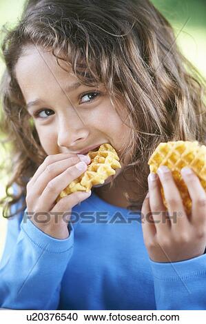 Smiling girl eating waffles View Large Photo Image Stock Image - Smiling girl eating waffles. Fotosearch