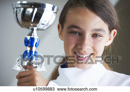 Smiling girl holding fencing trophy View Large Photo Image Stock Image - Smiling girl holding fencing trophy. Fotosearch
