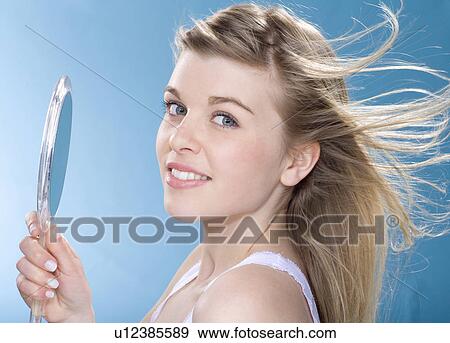 Smiling girl using hand mirror View Large Photo Image Stock Photo - Smiling girl using hand mirror. Fotosearch