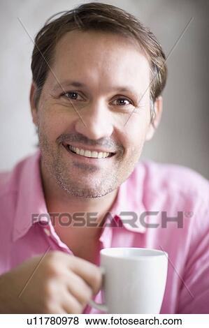 Stock Photo - Smiling man having cup of coffee. Fotosearch