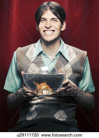 Smiling man holding fishbowl View Large Photo Image Stock Image - Smiling man holding fishbowl. Fotosearch