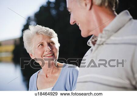 Smiling older couple talking outdoors View Large Photo Image Stock Photo - Smiling older couple talking outdoors. Fotosearch