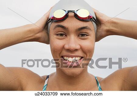 Smiling runner in goggles and swim cap View Large Photo Image Stock Photo - Smiling runner in goggles and swim cap. Fotosearch