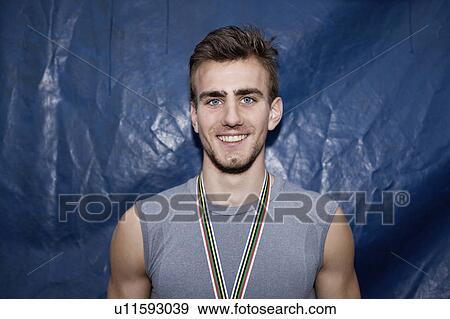 Smiling runner wearing medal View Large Photo Image Stock Photo - Smiling runner wearing medal. Fotosearch