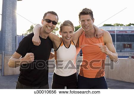 Stock Photograph - Smiling runners cheering together. Fotosearch