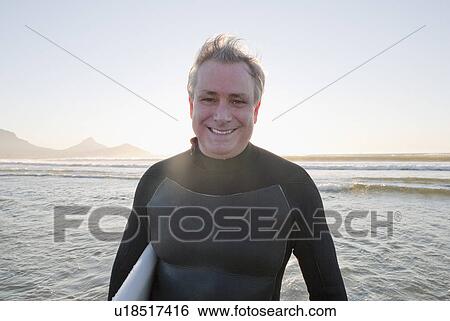 Smiling surfer in water View Large Photo Image Stock Photograph - Smiling surfer in water. Fotosearch