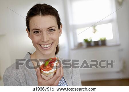 Smiling woman eating tomato sandwich View Large Photo Image Stock Photography - Smiling woman eating tomato sandwich. Fotosearch
