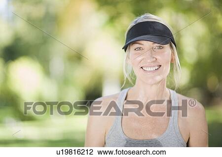 Smiling woman exercising outdoors View Large Photo Image Stock Image - Smiling woman exercising outdoors. Fotosearch