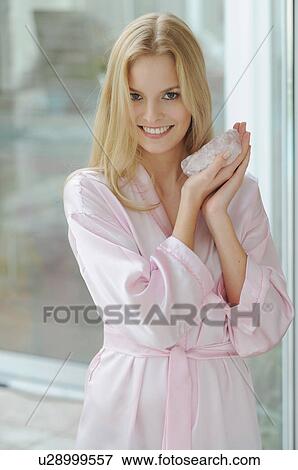 Smiling woman holding rose quartz View Large Photo Image Stock Photo - Smiling woman holding rose quartz. Fotosearch
