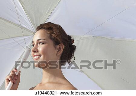 Smiling woman holding umbrella View Large Photo Image Stock Image - Smiling woman holding umbrella. Fotosearch
