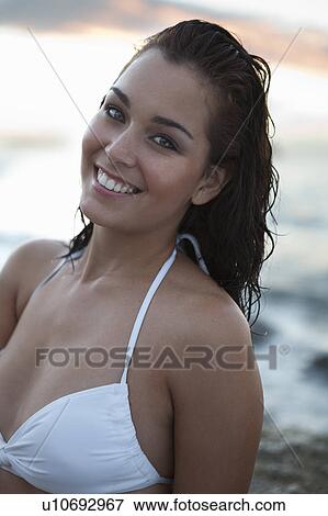 Stock Photo - Smiling woman in bikini on beach. Fotosearch