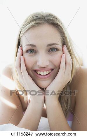 Smiling woman resting chin in hands View Large Photo Image Stock Photo - Smiling woman resting chin in hands. Fotosearch