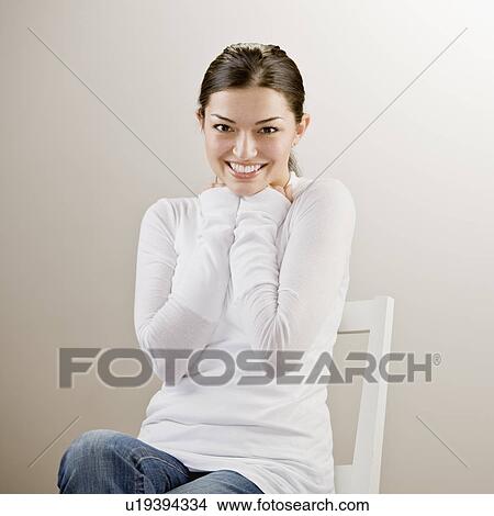 Smiling woman sitting in chair View Large Photo Image Picture - Smiling woman sitting in chair. Fotosearch