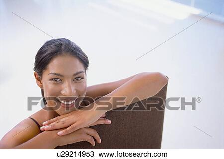 Smiling woman sitting in chair View Large Photo Image Stock Image - Smiling woman sitting in chair. Fotosearch