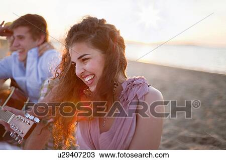 Smiling woman sitting on beach View Large Photo Image Stock Image - Smiling woman sitting on beach. Fotosearch
