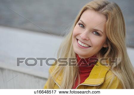 Smiling woman sitting outdoors View Large Photo Image Stock Photo - Smiling woman sitting outdoors. Fotosearch