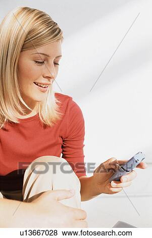 Smiling woman using cell phone View Large Photo Image Stock Photo - Smiling woman using cell phone. Fotosearch