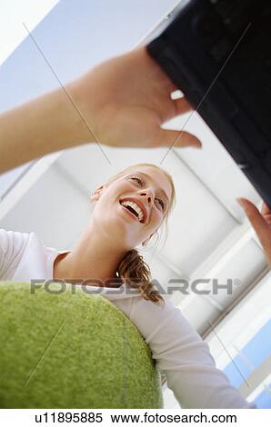 Smiling woman using laptop View Large Photo Image Stock Photography - Smiling woman using laptop. Fotosearch